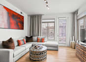 Thumbnail 8 of 39 - a living room with a white couch and a large red painting on the wall at 8000 Uptown Apartments, Colorado