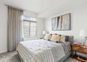 Thumbnail 16 of 39 - a bedroom with a large bed and a large window at 8000 Uptown Apartments, Broomfield, CO, 80021