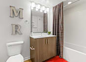 Thumbnail 13 of 39 - a bathroom with a toilet sink and bathtub at 8000 Uptown Apartments, Colorado