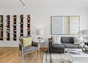 Thumbnail 10 of 39 - a living room filled with furniture and a large painting on a wall at 8000 Uptown Apartments, Broomfield, CO, 80021