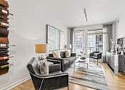 Thumbnail 9 of 39 - a living room with white walls and hardwood floors at 8000 Uptown Apartments, Colorado 80021