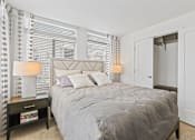Thumbnail 15 of 39 - a bedroom with a bed and two windows at 8000 Uptown Apartments, Colorado 80021