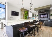 Thumbnail 7 of 35 - a kitchen with a long island with a marble countertop and four stools