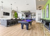 Thumbnail 11 of 35 - a game room with a pool table and bar