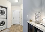 Thumbnail 10 of 48 - a small laundry room with a washer and dryer