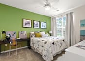 Thumbnail 11 of 48 - a bedroom with green walls and a white desk with a computer