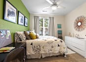 Thumbnail 12 of 48 - a bedroom with a large bed and green accent wall