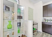 Thumbnail 8 of 48 - a glass display case with green vases in a kitchen