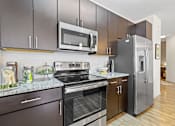 Thumbnail 2 of 48 - a modern kitchen with stainless steel appliances and a stainless steel refrigerator