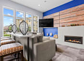 Thumbnail 26 of 48 - a living room with a blue accent wall and a fireplace