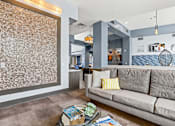 Thumbnail 25 of 48 - seating area with yellow cushions in clubhouse at Westlink at Oak Station Apartments in Lakewood, CO