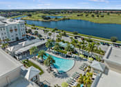 Thumbnail 46 of 65 - A large swimming pool surrounded by palm trees and lounge chairs. at Centre Pointe Apartments, Florida