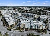 Thumbnail 63 of 65 - A large, modern complex of buildings with a parking lot in front. at Centre Pointe Apartments, Melbourne, FL