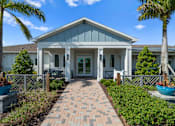 Thumbnail 43 of 46 - the front of a house with a walkway and palm trees at Artesia at Lakewood Ranch Apartments, Bradenton, FL