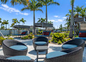 Thumbnail 34 of 46 - blue and brown chairs positioned around table outdoors at Artesia at Lakewood Ranch Apartments, Bradenton, 34211