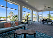 Thumbnail 25 of 46 - a living room with a couch and a table with chairs and windows at Artesia at Lakewood Ranch Apartments, Bradenton, 34211