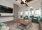 Thumbnail 11 of 46 - a living room with a coffee table and a television at Artesia at Lakewood Ranch Apartments, Bradenton
