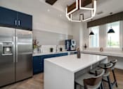 Thumbnail 17 of 46 - a kitchen with stainless steel appliances and a white counter top at Artesia at Lakewood Ranch Apartments, Florida