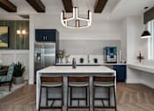 Thumbnail 16 of 46 - view of clubhouse with white table and kitchen at Artesia at Lakewood Ranch Apartments, Florida