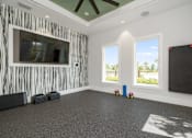 Thumbnail 22 of 46 - a room with a large screen on the wall and a projector on the floor at Artesia at Lakewood Ranch Apartments, Bradenton, Florida