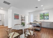 Thumbnail 7 of 40 - a dining room with a marble table and four chairs and a kitchen with a sink at Odyssey, Florida
