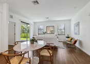 Thumbnail 6 of 40 - a living room with a white couch and a table and chairs at Odyssey, Florida