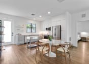 Thumbnail 5 of 40 - a kitchen and dining room with a table and chairs at Odyssey, Fort Myers, Florida