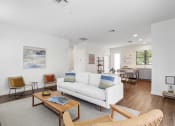 Thumbnail 9 of 40 - a living room with a white couch and a coffee table at Odyssey, Florida