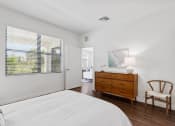 Thumbnail 11 of 40 - a bedroom with a bed and a dresser and a window at Odyssey, Florida