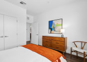 Thumbnail 18 of 40 - bedroom with white walls and a white bed with an orange blanket at Odyssey, Fort Myers, FL, 33905
