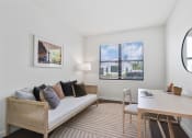 Thumbnail 21 of 40 - a living room with a couch and a desk and a window at Odyssey, Florida