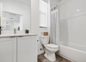 Thumbnail 16 of 40 - a bathroom with a shower and a toilet and a sink at Odyssey, Fort Myers, Florida