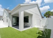 Thumbnail 24 of 40 - the exterior of a white house with a lawn and two chairs at Odyssey, Florida