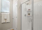 Thumbnail 10 of 37 - a white bathroom with a shower and a window at Soleil at Canyon Trails Apartments, Goodyear, Arizona