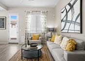 Thumbnail 16 of 37 - a living room with a couch and a coffee table at Soleil at Canyon Trails Apartments, Goodyear, Arizona