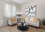 Thumbnail 17 of 37 - a living room with a couch and a coffee table at Soleil at Canyon Trails Apartments, Goodyear, AZ, 85338