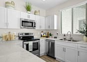 Thumbnail 13 of 37 - a modern kitchen with white cabinets and stainless steel appliances at Soleil at Canyon Trails Apartments, Goodyear, 85338