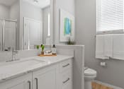 Thumbnail 11 of 43 - a bathroom with a sink and a toilet and a mirror at Sienna at South Mountain Apartments, Laveen