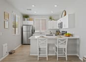 Thumbnail 4 of 43 - a kitchen with white cabinets and a white island with stools at Sienna at South Mountain Apartments, Laveen, 85339
