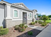 Thumbnail 15 of 43 - a white brick house with a sidewalk in front of it at Sienna at South Mountain Apartments, Laveen, AZ