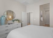 Thumbnail 24 of 43 - a bedroom with a white bed and a mirror at Sienna at South Mountain Apartments, Laveen