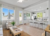 Thumbnail 21 of 43 - an open living room and kitchen with a dining table and chairs at Sienna at South Mountain Apartments, Laveen, Arizona