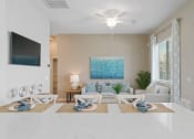 Thumbnail 20 of 43 - a living room with a couch and a ceiling fan at Sienna at South Mountain Apartments, Arizona