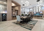 Thumbnail 27 of 65 - A modern dining room with a large table and chairs. at Centre Pointe Apartments, Melbourne, Florida