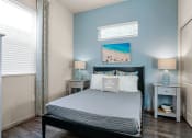 Thumbnail 13 of 33 - a bedroom with a bed and two nightstands and a window at Olive Queen Creek Apartments, Queen Creek, AZ