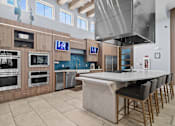 Thumbnail 25 of 65 - A modern kitchen with a large island and stainless steel appliances. at Centre Pointe Apartments, Melbourne, 32940