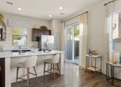 Thumbnail 2 of 33 - a kitchen with an island and a door to a patio at Olive Queen Creek Apartments, Arizona