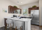 Thumbnail 1 of 33 - a kitchen with stainless steel appliances and a counter with two stools at Olive Queen Creek Apartments, Arizona