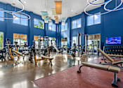 Thumbnail 34 of 65 - A gym with a variety of equipment including treadmills, weights, and exercise machines. at Centre Pointe Apartments, Melbourne, Florida