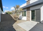 Thumbnail 17 of 33 - a view of the front of a house with a sidewalk and a tree at Olive Queen Creek Apartments, Arizona